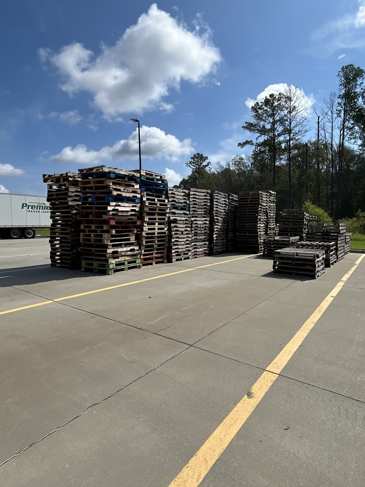 Mixed stacks of wood pallets in a distribution yard in the Carolinas